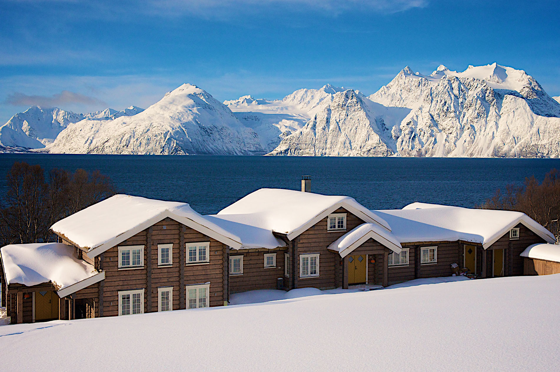 Lyngen Lodge in winter with a view of the mountains, Norway