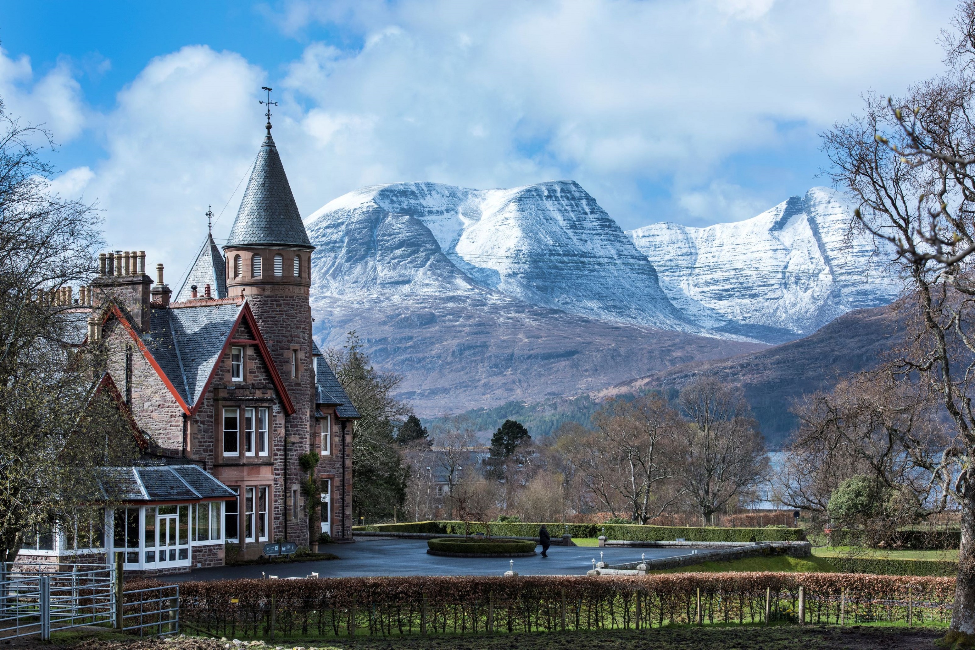 External view of The Torridon Resort with the snow-capped mountains beyond in the Scottish Highlands
