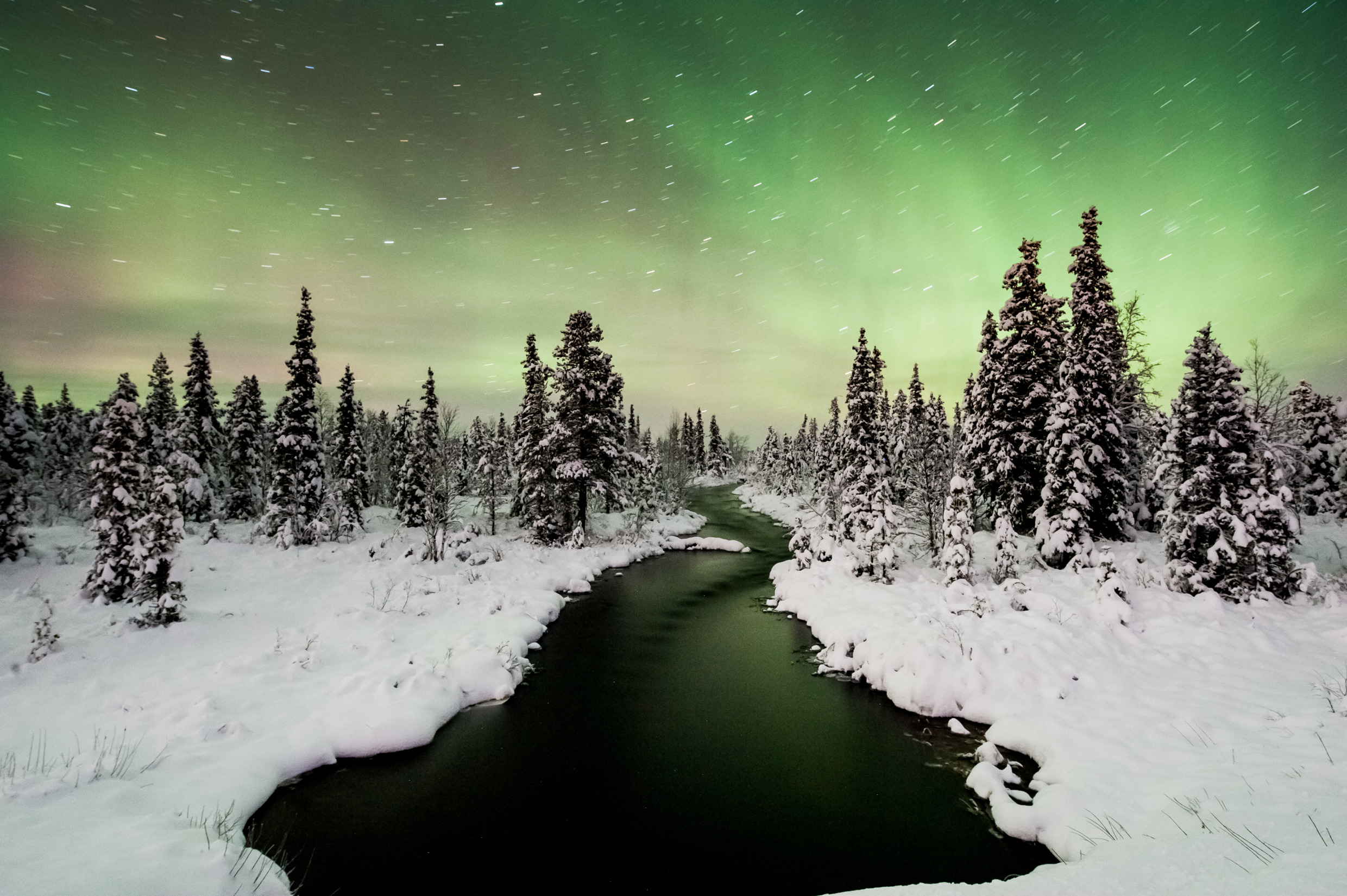 Northern Lights in front of a river in winter